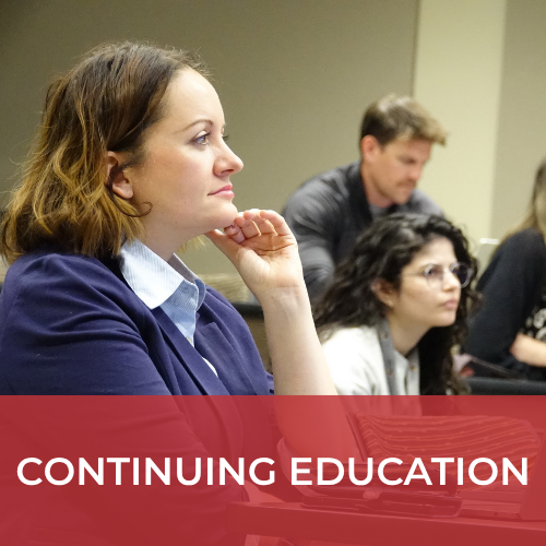 A picture of Dr. Odessa Addison listening to a course in a classroom
